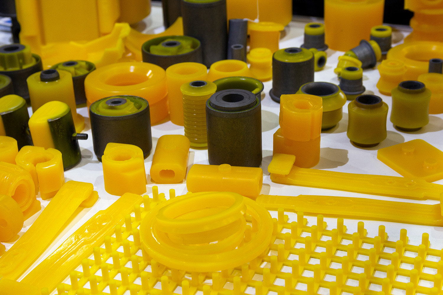 Close-up of translucent white polymer pellets used in chemical manufacturing and custom tolling processes